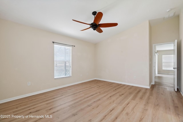 18710 Dobson Dr, Hudson, FL 34667 - empty room featuring light wood-style flooring, a ceiling fan, and baseboards