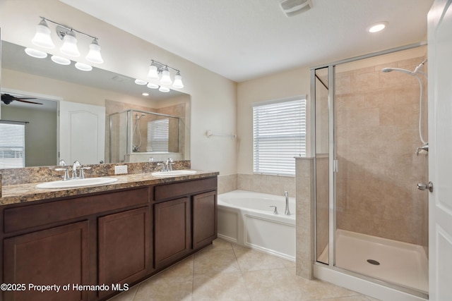 18710 Dobson Dr, Hudson, FL 34667 - bathroom featuring a shower stall, a garden tub, double vanity, and tile patterned flooring