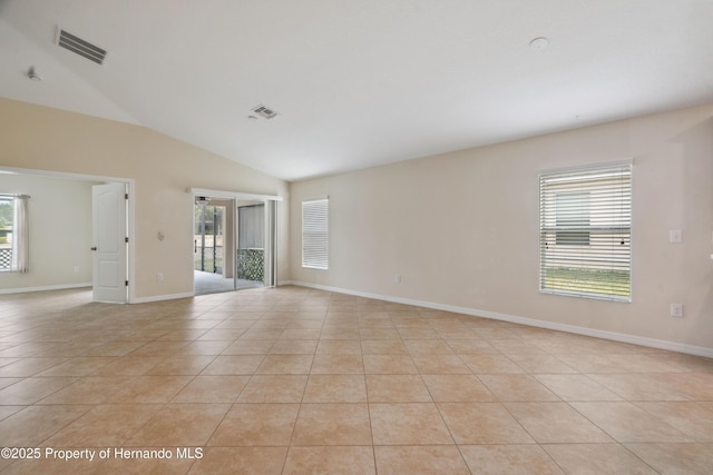 18710 Dobson Dr, Hudson, FL 34667 - spare room featuring light tile patterned flooring, lofted ceiling, and baseboards