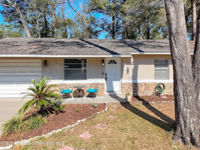 1531 NE 38th St, Ocala, FL 34479 - view of front of property with stone siding, stucco siding, and roof with shingles