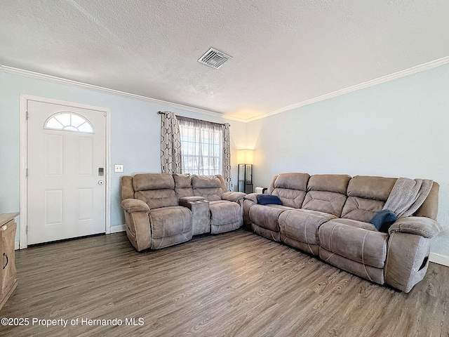 1531 NE 38th St, Ocala, FL 34479 - living room featuring wood finished floors, crown molding, a textured ceiling, and baseboards