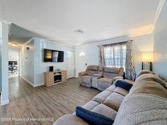 1531 NE 38th St, Ocala, FL 34479 - living area with crown molding, wood finished floors, a textured ceiling, and baseboards