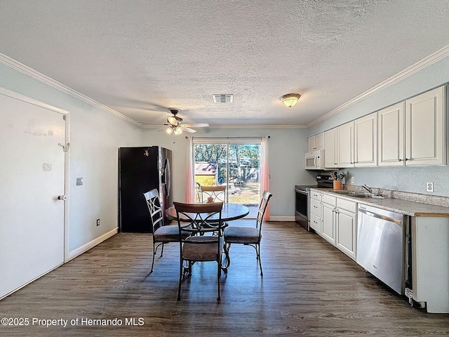 1531 NE 38th St, Ocala, FL 34479 - dining area featuring crown molding, a textured ceiling, dark wood finished floors, ceiling fan, and baseboards