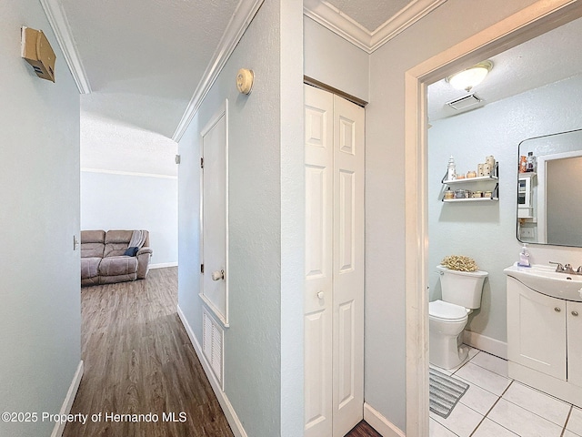 1531 NE 38th St, Ocala, FL 34479 - corridor with crown molding, baseboards, and light wood-type flooring