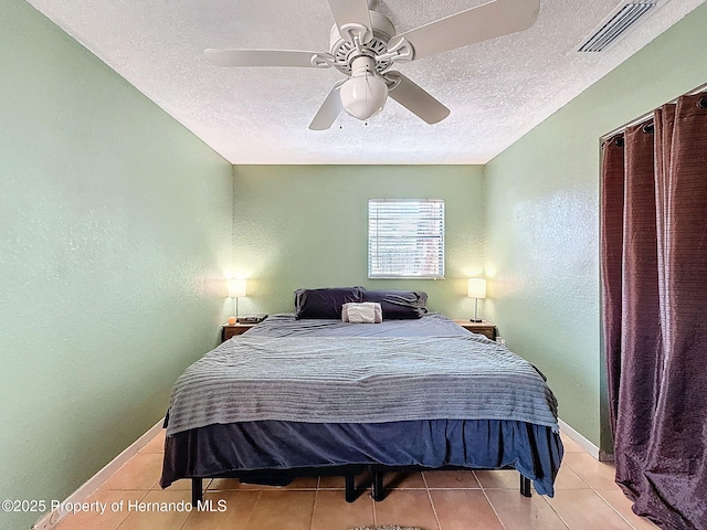 1531 NE 38th St, Ocala, FL 34479 - tiled bedroom with a textured ceiling, a textured wall, a ceiling fan, and baseboards