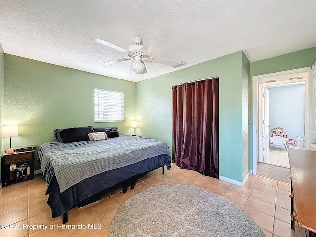 1531 NE 38th St, Ocala, FL 34479 - tiled bedroom with a textured ceiling, a ceiling fan, and baseboards