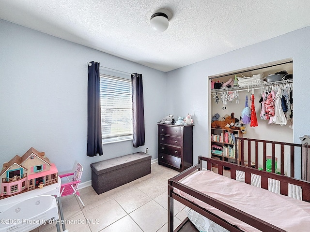 1531 NE 38th St, Ocala, FL 34479 - bedroom with a textured ceiling, light tile patterned flooring, a closet, and baseboards