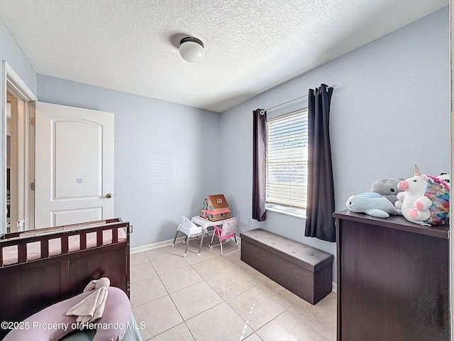 1531 NE 38th St, Ocala, FL 34479 - bedroom featuring a textured ceiling, light tile patterned floors, and baseboards