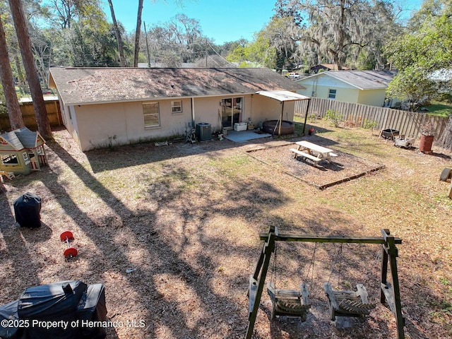 1531 NE 38th St, Ocala, FL 34479 - back of house with a patio, central AC, and a fenced backyard