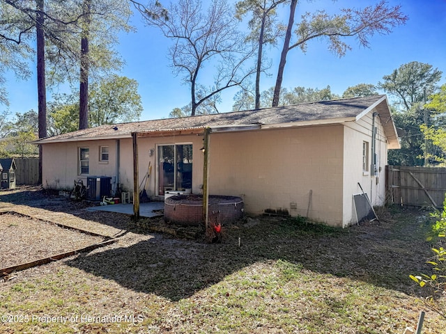 1531 NE 38th St, Ocala, FL 34479 - rear view of house with cooling unit, a patio, and concrete block siding