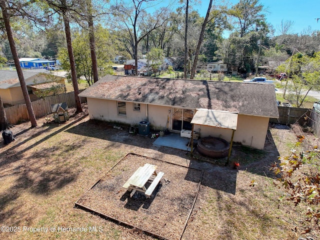 1531 NE 38th St, Ocala, FL 34479 - rear view of house featuring a fenced backyard, a shingled roof, a patio, and view of scattered trees