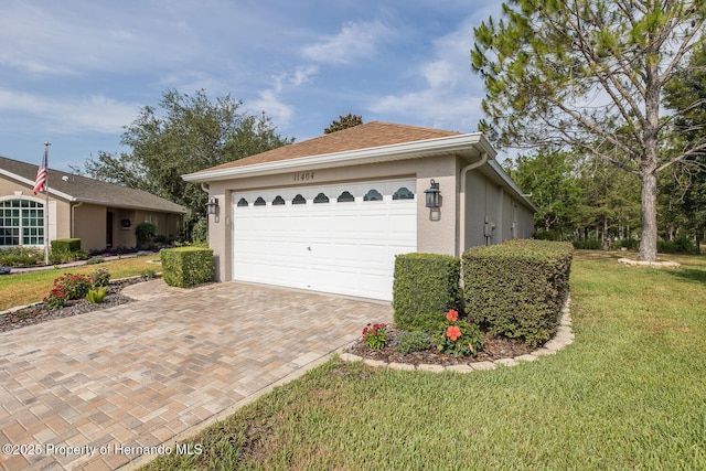 11404 Inman Ct, Spring Hill, FL 34609 - view of property exterior with stucco siding, decorative driveway, a yard, and a garage