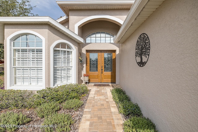 11404 Inman Ct, Spring Hill, FL 34609 - property entrance with stucco siding and french doors