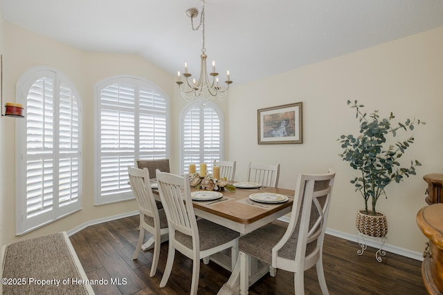 11404 Inman Ct, Spring Hill, FL 34609 - dining space with a chandelier, wood finished floors, lofted ceiling, and baseboards