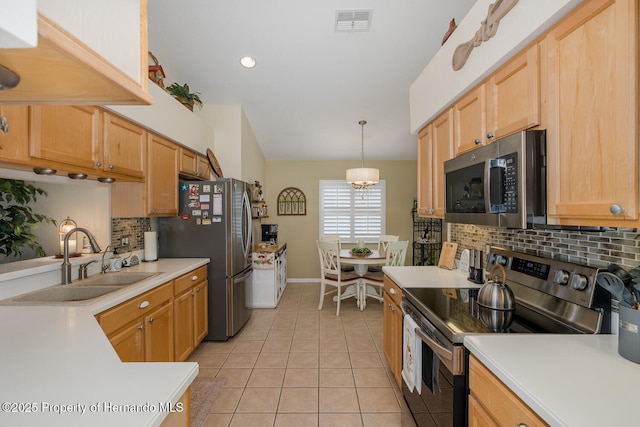 11404 Inman Ct, Spring Hill, FL 34609 - kitchen featuring appliances with stainless steel finishes, a sink, decorative backsplash, light tile patterned flooring, and light countertops