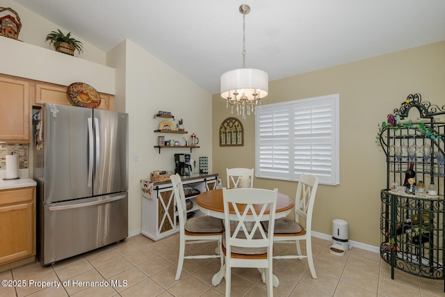 11404 Inman Ct, Spring Hill, FL 34609 - dining room featuring light tile patterned floors, a chandelier, baseboards, and lofted ceiling