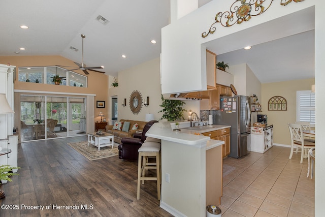 11404 Inman Ct, Spring Hill, FL 34609 - kitchen with a ceiling fan, open floor plan, freestanding refrigerator, a sink, and high vaulted ceiling