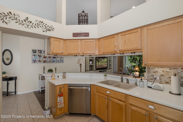 11404 Inman Ct, Spring Hill, FL 34609 - kitchen with dishwasher, a sink, light countertops, light tile patterned floors, and backsplash