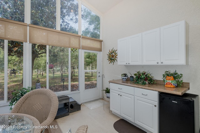11404 Inman Ct, Spring Hill, FL 34609 - kitchen with fridge and white cabinetry