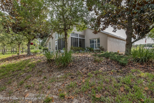 11404 Inman Ct, Spring Hill, FL 34609 - rear view of property featuring stucco siding and a sunroom