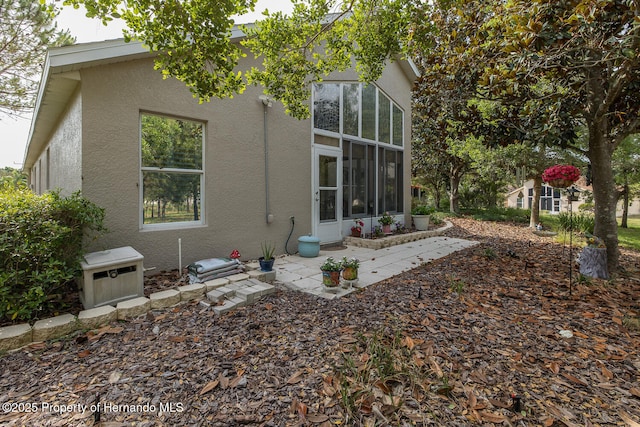 11404 Inman Ct, Spring Hill, FL 34609 - rear view of property with stucco siding and a patio
