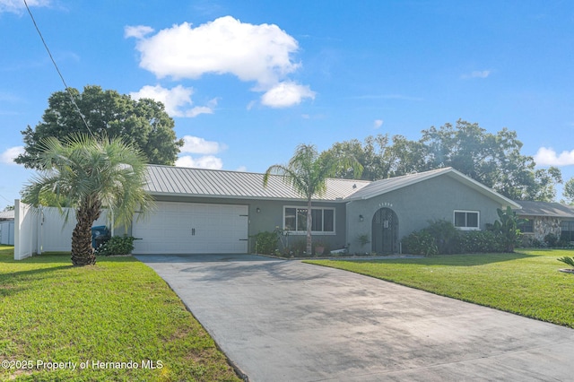 11226 Murraysville Dr, Spring Hill, FL 34609 - ranch-style house featuring stucco siding, concrete driveway, an attached garage, and metal roof