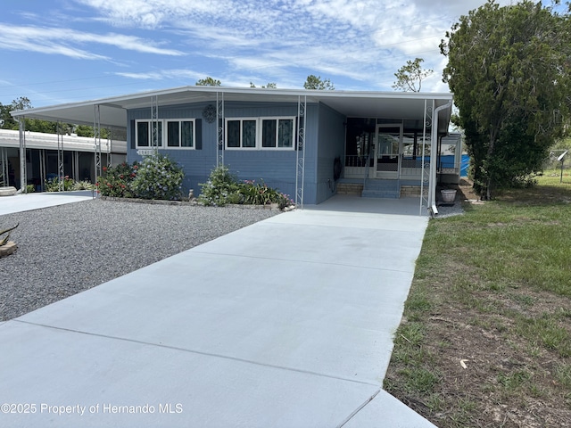 12325 Fairway Ave, Brooksville, FL 34613 - view of front of house featuring a carport, driveway, and entry steps