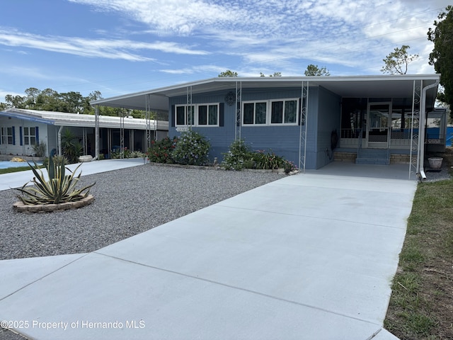 12325 Fairway Ave, Brooksville, FL 34613 - manufactured / mobile home with an attached carport and concrete driveway