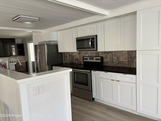 12325 Fairway Ave, Brooksville, FL 34613 - kitchen with stainless steel appliances, beamed ceiling, white cabinets, light wood-type flooring, and backsplash