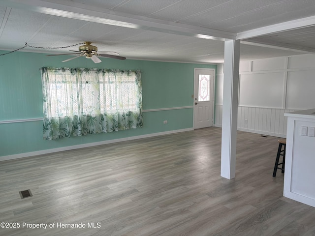 12325 Fairway Ave, Brooksville, FL 34613 - spare room featuring ceiling fan, wood finished floors, and beam ceiling