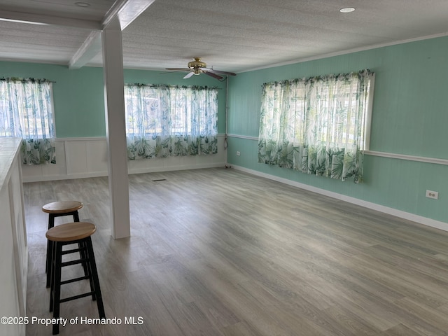 12325 Fairway Ave, Brooksville, FL 34613 - unfurnished room with ceiling fan, wood finished floors, and a wainscoted wall