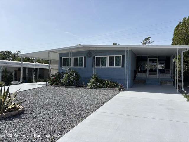 12325 Fairway Ave, Brooksville, FL 34613 - manufactured / mobile home featuring concrete driveway and an attached carport