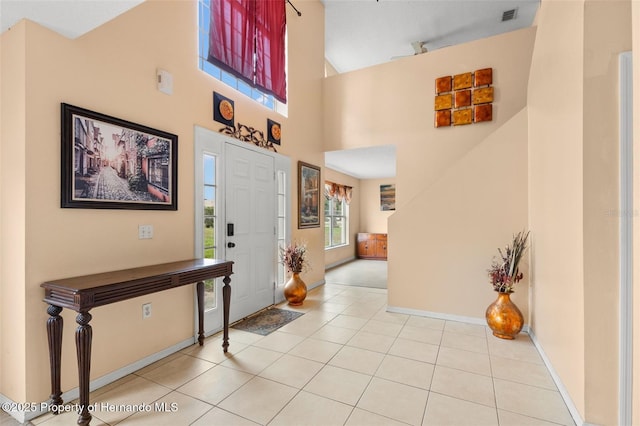 4148 Landover Blvd, Spring Hill, FL 34609 - foyer entrance featuring a towering ceiling, tile patterned flooring, and baseboards