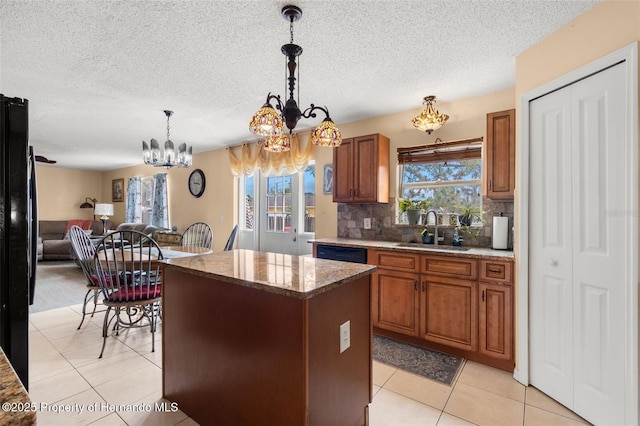 4148 Landover Blvd, Spring Hill, FL 34609 - kitchen with a sink, a chandelier, a kitchen island, brown cabinetry, and tasteful backsplash