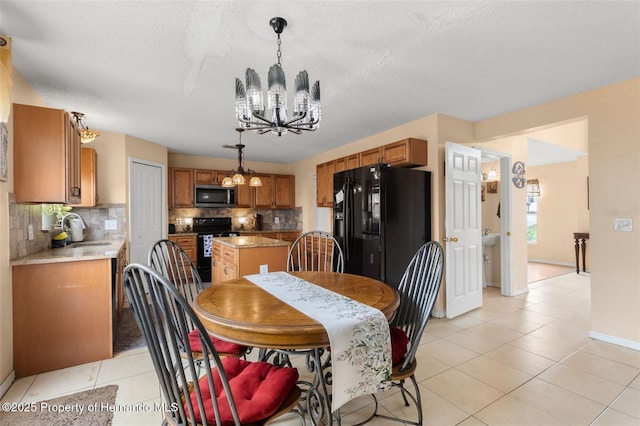 4148 Landover Blvd, Spring Hill, FL 34609 - dining space featuring a chandelier, light tile patterned floors, baseboards, and a textured ceiling