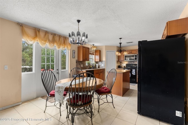 4148 Landover Blvd, Spring Hill, FL 34609 - dining area featuring a chandelier, a textured ceiling, and light tile patterned floors