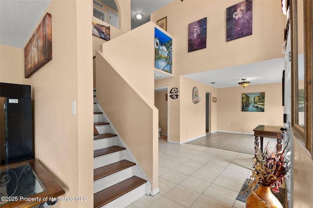 4148 Landover Blvd, Spring Hill, FL 34609 - staircase featuring tile patterned floors and baseboards