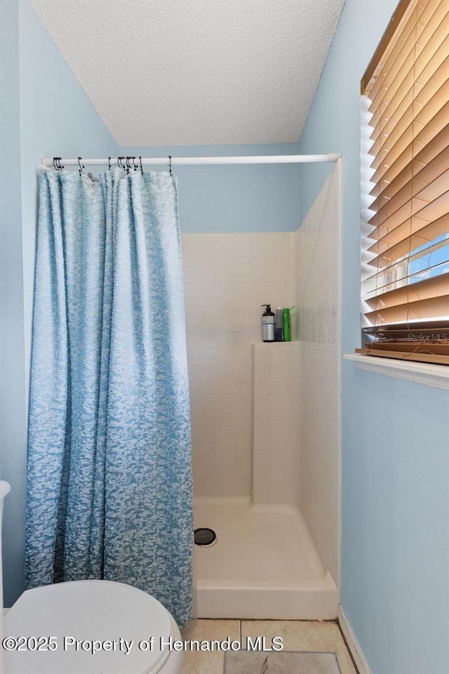 4148 Landover Blvd, Spring Hill, FL 34609 - full bath with toilet, a tile shower, a textured ceiling, and tile patterned floors