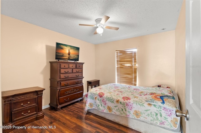 4148 Landover Blvd, Spring Hill, FL 34609 - bedroom with dark wood-style floors, a textured ceiling, a ceiling fan, and baseboards