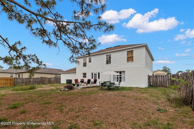 4148 Landover Blvd, Spring Hill, FL 34609 - back of property featuring an outdoor fire pit and a patio area