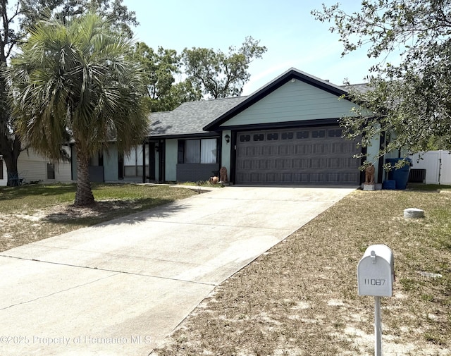 11087 Addison St, Spring Hill, FL 34609 - single story home featuring a garage, concrete driveway, and a shingled roof