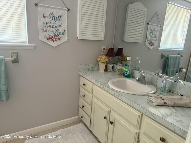 11087 Addison St, Spring Hill, FL 34609 - bathroom with vanity, plenty of natural light, and tile patterned flooring