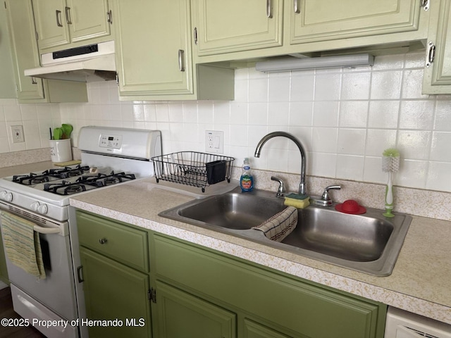 11087 Addison St, Spring Hill, FL 34609 - kitchen featuring white range with gas cooktop, green cabinetry, under cabinet range hood, and light countertops