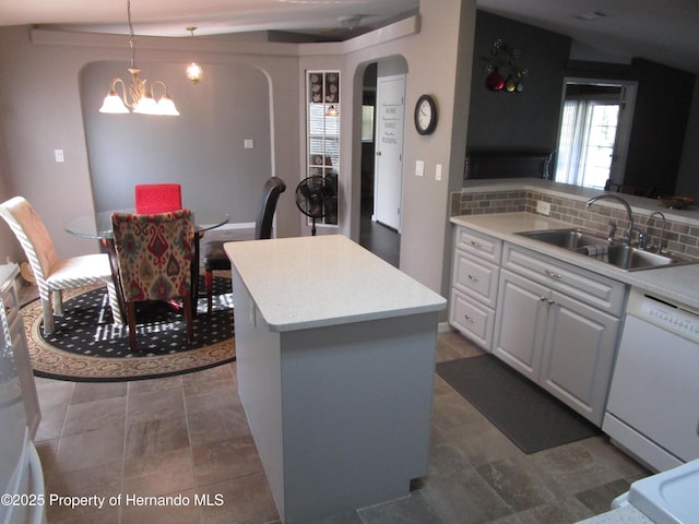 8423 Dickens Ave, Brooksville, FL 34613 - kitchen featuring dishwasher, arched walkways, a chandelier, tasteful backsplash, and a center island
