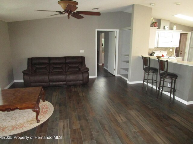 8423 Dickens Ave, Brooksville, FL 34613 - living area featuring vaulted ceiling, dark wood finished floors, and ceiling fan