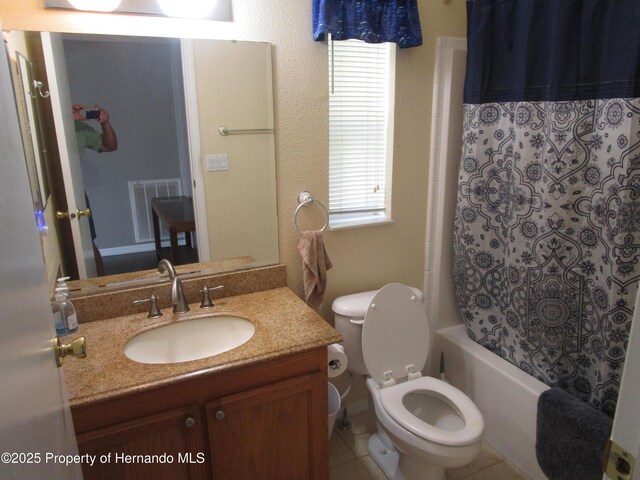 8423 Dickens Ave, Brooksville, FL 34613 - bathroom featuring vanity, shower / bath combo with shower curtain, and tile patterned floors