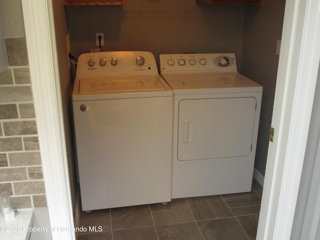 8423 Dickens Ave, Brooksville, FL 34613 - laundry room with separate washer and dryer and dark tile patterned floors