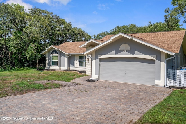 204 Oak Lake Dr, Spring Hill, FL 34608 - single story home with stucco siding, an attached garage, decorative driveway, and a front yard