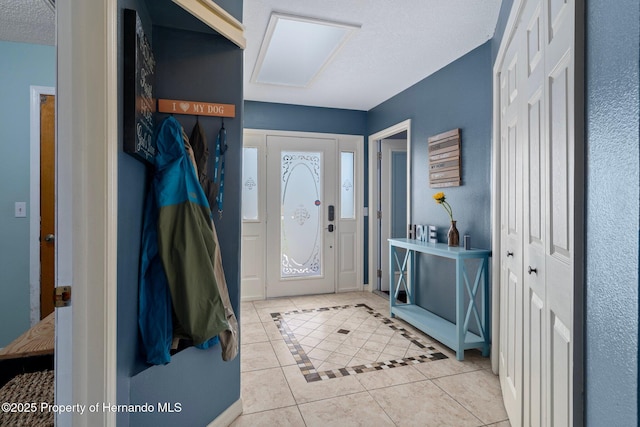 204 Oak Lake Dr, Spring Hill, FL 34608 - foyer entrance with light tile patterned floors and a textured ceiling
