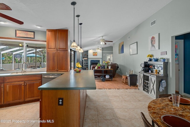 204 Oak Lake Dr, Spring Hill, FL 34608 - kitchen with a ceiling fan, dishwasher, brown cabinetry, and a fireplace